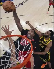  ?? ?? Chicago Bulls center Andre Drummond, center, shoots between Golden State Warriors forward Andrew Wiggins, right, and center Trayce Jackson-Davis during the first half Thursday in San Francisco.