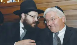  ?? (Courtesy) ?? RABBI YEHUDA TEICHTAL speaks with German Foreign Minister Frank-Walter Steinmeier during the inaugurati­on of the Berlin Jewish Community Center in 2007.