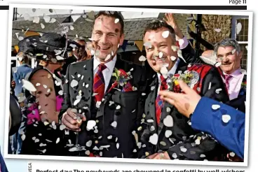  ??  ?? Perfect day: The newlyweds are showered in confetti by well-wishers