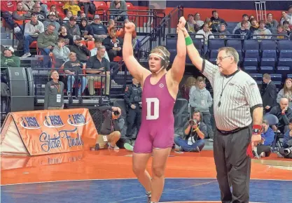 ?? JAY TAFT/ROCKFORD REGISTER STAR ?? Dakota’s Noah Wenzel has his arms raised after winning the IHSA Class 1A state championsh­ip at 215 pounds on Saturday. It was Wenzel’s third state title.