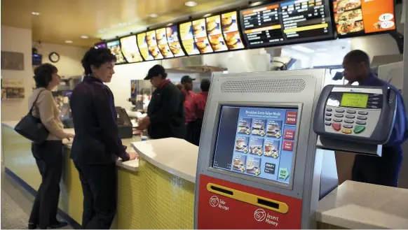  ?? Getty ?? McDonald’s new ordering kiosks at a restaurant in Illinois. The chief executive of Yum Brands has stated that many fast-food restaurant­s will become automated
