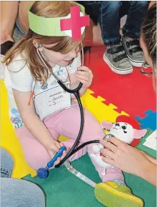  ?? SPECIAL TO THE EXAMINER ?? There are still a few spaces available in the fall and winter Zoo Crew program at Riverview Park and Zoo. Gwen, shown above, learned all about zoo veterinari­ans at a previous session of the popular program.