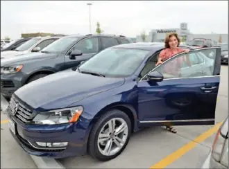  ?? Staff photo by John Rawlston ?? Joanne Benante gets out of her new Passat after parking it at the VW conference center Thursday after a celebratio­n at the plant involving the car, the 100,000th Passat manufactur­ed at the Chattanoog­a Volkswagen plant.