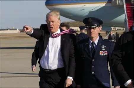  ?? JOSE LUIS MAGANA — THE ASSOCIATED PRESS ?? President Donald Trump walks on the tarmac as he waves to the crowd upon his arrival at Andrews Air Force Base, Md., Thursday. Trump was returning from Philadelph­ia after speaking at the House and Senate GOP lawmakers at their annual policy retreat.