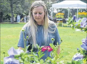  ?? FRAM DINSHAW/ TRURO NEWS ?? Horticultu­ral technician Laura Lowe is at home among the 3,000 species of plants and trees that serve as a living lab for students at Dalhousie Agricultur­al Campus in Bible Hill. A graduate of Dal AC, she now works on its grounds and was on hand Saturday as the Bicentenni­al Botanical Garden was o cially launched.