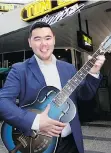  ??  ?? During a reception at Tom Lee Music’s Granville Street store, Kenneth Lee did a little busking for the crowd while strumming a $10,000 National Reso-Phonic dobro.