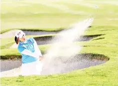  ?? — AFP photo ?? Moriya Jutanugarn of Thailand hits out of a bunker on the 18th green during round two of the Hugel-JTBC Championsh­ip at the Wilshire Country Club on April 20, 2018 in Los Angeles, California.