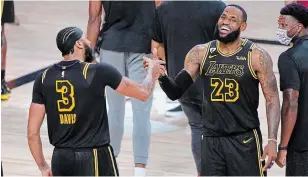  ?? MARK J. TERRILL THE ASSOCIATED PRESS FILE PHOTO ?? Lakers’ LeBron James celebrates with teammate Anthony Davis after their Western Conference finals victory over Denver. The Black Mamba jerseys were designed by Kobe Bryant.