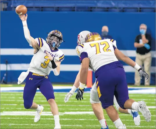  ?? MICHAEL GARD/POST-TRIBUNE ?? Hobart quarterbac­k Riley Johnston, left, passes the ball during the Class 4A state final against Roncalli at Lucas Oil Stadium in Indianapol­is on Friday.