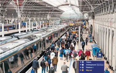  ?? ALAMY. ?? Passengers board a Great Western Railway service at Paddington station in September 2018. Has the Paddington Station 24/7 documentar­y series given a false image of rail travel today?