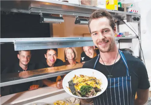  ?? Picture: BRENDAN RADKE ?? DELICIOUS SERVE: Caffiend's chef Shaun Roseweir (front) with (from left) Maxima Detouillon, Kevin Quintana, Fern Campbell and Jorge Herrando with the miso scramble, named one of the five best egg dishes in the country.