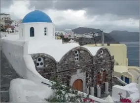  ??  ?? GOD’S HAND: Juliet Leslie was enamoured of the whitewashe­d buildings on the Greek island of Santorini.