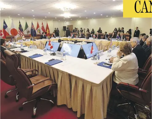  ?? MICK TSIKAS / AAP IMAGE VIA AP / THE CANADIAN PRESS ?? Prime Minister Justin Trudeau’s empty seat is seen at a TPP meeting in Vietnam. No one doubts he had reasons for refusing to sign onto the deal, but none of the motives that have been floated seem creditable, writes Andrew Coyne.