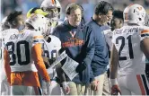  ?? ROBERT WILLETT/ASSOCIATED PRESS ?? Virginia coach Bronco Mendenhall talks with his players during a timeout on Saturday in Chapel Hill, N.C.