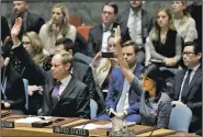  ?? AP/MARK LENNIHAN ?? Matthew Rycroft, Britain’s U.N. ambassador, and U.S. Ambassador Nikki Haley vote in favor of new North Korea sanctions on Friday at United Nations headquarte­rs.