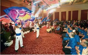  ??  ?? Eye-catching: Performers putting on a colourful show during the launching of ‘theRakyat’ portal.