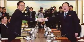  ?? EPA PIC ?? South Korean Unificatio­n Minister Cho Myoung-gyon (left) shaking hands with North Korea’s chief delegate Ri Son-gwon in Panmunjom, North Korea, yesterday.