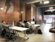 ?? NICHOLAS BUONANNO — NBUONANNO@TROYRECORD.COM ?? People working out of the Troy Innovation Garage on Thursday.