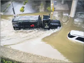  ?? MARIE D. DE JESUS — HOUSTON CHRONICLE VIA AP ?? A Houston Police Water Rescue vehicle mobilizes by a stranded car on Houston Ave., during Tropical Storm Beta on Tuesday in Houston.