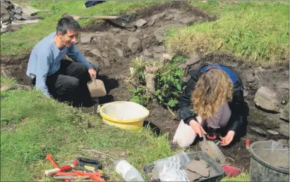  ??  ?? Volunteers assess the trench excavated at Dunollie, but more helpers are needed for a second dig.