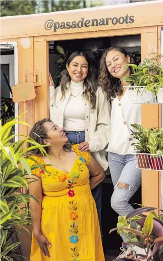  ?? Photograph­s by Silvia Razgova For The Times ?? THE ROLLING Pasadena Roots plant shop is the dream of Vilma Alvarado, left, and her family, especially daughters Cindy, center, and Wendy.