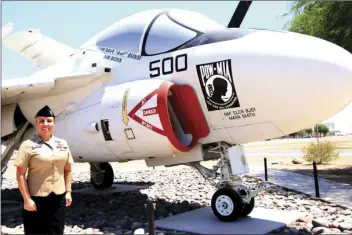  ??  ?? Susana Saenz, U.S. Navy Petty Officer - 1st Class, Thursday, who was recently awarded the 2017 American Legion Auxiliary Sevicewoma­n of the Year tribute stands near an A-6 Intruder at NAFEC. WILLIAM ROLLER PHOTO