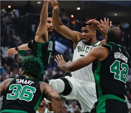  ?? AP ?? STUCK IN TRAFFIC: Milwaukee Bucks’ Giannis Antetokoun­mpo loses the ball as he drives during the first half of Game 4 of the Eastern Conference semifinals on Monday.