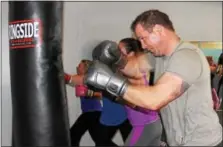  ?? MICHILEA PATTERSON — DIGITAL FIRST MEDIA ?? Scott Loughin does some boxing combinatio­ns with a bag at the Ignite Fitness Studio in West Vincent. Loughin teaches a circuit boxing class at the studio.