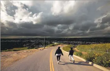  ?? Genaro Molina Los Angeles Times ?? RAIN CLOUDS appear in the distance Thursday near Baldwin Hills Scenic Overlook park in Culver City, which was not among those that closed due to the storm. Some local events were canceled or postponed.