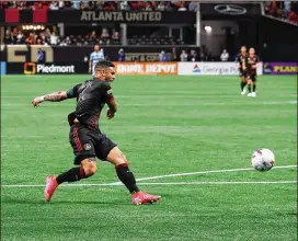  ?? CURTIS COMPTON/CURTIS.COMPTON@AJC.COM ?? Atlanta United wing Dom Dwyer scores against Sporting KC to give the club a 2-0 lead in their season-opening 3-1 win Sunday.