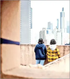  ??  ?? Saudi sisters Rawan (in yellow), 18, and Reem, 20, (both using adopted aliases) stand next to each other during an interview with AFP in Hong Kong.