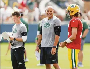  ?? Matt Ludtke / Associated Press ?? Jets coach Robert Saleh, offensive coordinato­r Mike LaFleur, left, and Packers quarterbac­k Aaron Rodgers chat during a joint training camp practice on Aug. 18, 2021, in Green Bay, Wis.