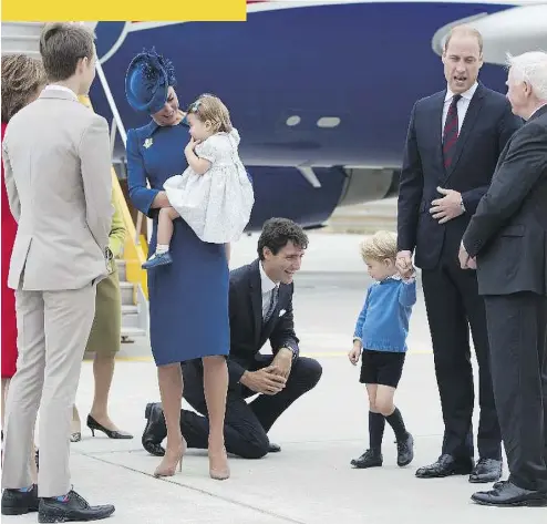  ?? JONATHAN HAYWARD / AFP / GETTY IMAGES ?? Prime Minister Justin Trudeau, centre, kneels to talk to Prince George as Prince William speaks with the Governor General David Johnston, right, and Catherine, Duchess of Cambridge, left-of-centre, holds daughter Princess Charlotte in Victoria. Trudeau was seen trying to high-five the young prince, who denied the gesture.