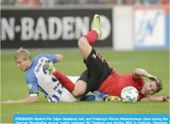  ?? — AP ?? FREIBURG: Berlin’s Per Ciljan Skjelbred, left, and Freiburg’s Florian Niederlech­ner clash during the German Bundesliga soccer match between SC Freiburg and Hertha BSC in Freiburg, Germany, yesterday.