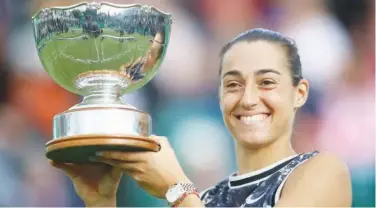  ?? Associated Press ?? ↑ Caroline Garcia holds the trophy after beating Croatia’s Donna Vekic in the final of the Nottingham Open on Sunday.