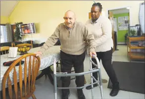  ?? Erik Trautmann / Hearst Connecticu­t Media ?? STAR resident Jimmy Natale gets help from his aid Inez Brown on Friday at his group home in Norwalk.