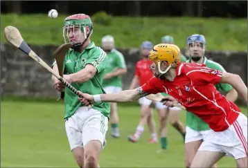  ??  ?? Daniel Keating of St. James’ gets his strike away under pressure from Fethard’s Mark Wallace.