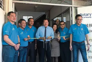  ??  ?? Giving back to the community: Tan (fourth from left) officiates the opening of the JHM Dialysis Centre, which is managed by the Penang Rotary Club, to benefit members of the community.