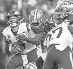  ?? JEFF LEWIS/AP ?? San Francisco 49ers cornerback Deommodore Lenoir sacks quarterbac­k Matthew Stafford on Monday.