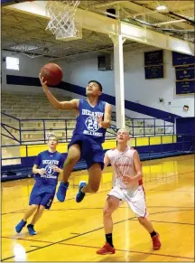  ?? Photo by Mike Eckels ?? Decatur’s Marck Guadarrama (24) breaks away from a Eureka Springs player for a layup during the Bulldog- Highlander basketball game at Peterson Gym in Decatur on June 14. Decatur, Eureka Springs and Gentry all participat­ed in the second round of the...