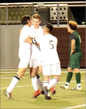  ?? Graham Thomas/Herald-Leader ?? Siloam Springs soccer players, from left, Christian Marroquin, Eli Jackson and Jose Serrana celebrate after Jackson scored a goal just more than a minute into Monday’s match against Muskogee, Okla. The Panthers defeated the Roughers 3-1 at Panther...