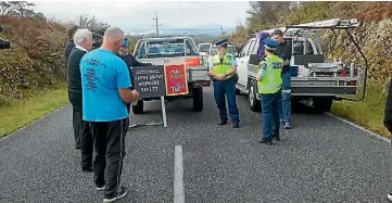  ??  ?? Pike River protesters are spoken to by West Coast area commander Mel Aitken at the mine access road protest on Thursday.