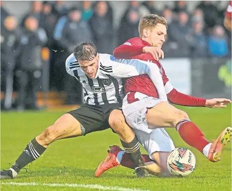  ?? ?? TERRIFIC TUSSLE: Fraserburg­h’s Ryan Sargent loses out to a sliding challenge by Arbroath’s Thomas O’brien.