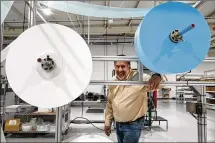  ?? JEFF ROBERSON PHOTOS/AP ?? Angstrom Manufactur­ing president Chris Carron poses for a photo with machinery the company uses to make surgical masks March 23 in Ste. Genevieve, Mo.