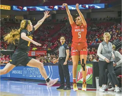 ?? RICHARDSON/BALTIMORE SUN PHOTOS KEVIN ?? Maryland guard Brinae Alexander (5) makes one of her six 3-pointers in Tuesday night’s win over Iowa at Xfinity Center in College Park.