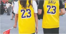  ?? TYRONE SIU/ REUTERS ?? Fans wear LeBron James jerseys before a game in Shenzhen, China between the Brooklyn Nets and the Los Angeles Lakers.