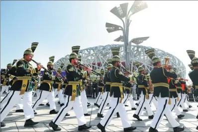  ?? ZHANG YU / CHINA NEWS SERVICE ?? A Pakistani military band marches in front of the National Stadium, known as the Bird’s Nest, in Beijing on Wednesday. It was taking part in the fifth military marching band festival parade for the Shanghai Cooperatio­n Organizati­on at the Olympic Park.