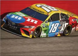  ?? JARED C. TILTON/GETTY IMAGES/TNS 2021 ?? Kyle Busch drives the No. 18 M&M’s Toyota during the NASCAR Cup Series Cook Out Southern 500 at Darlington Raceway in 2021. Today’s race at Darlington is a throwback nod to the origins of NASCAR.