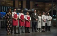  ?? ?? “Top Chef” contestant­s line up to learn their fates after completing the Restaurant Wars challenge in Season 15, based in Denver.