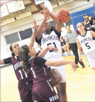  ?? Photos by Ernest A. Brown ?? Alicia Harmon (51, right) came off the bench to provide a spark for the Burrillvil­le girls basketball team in the second half of a 35-27 victory over Woonsocket Tuesday night at the Broncodome.